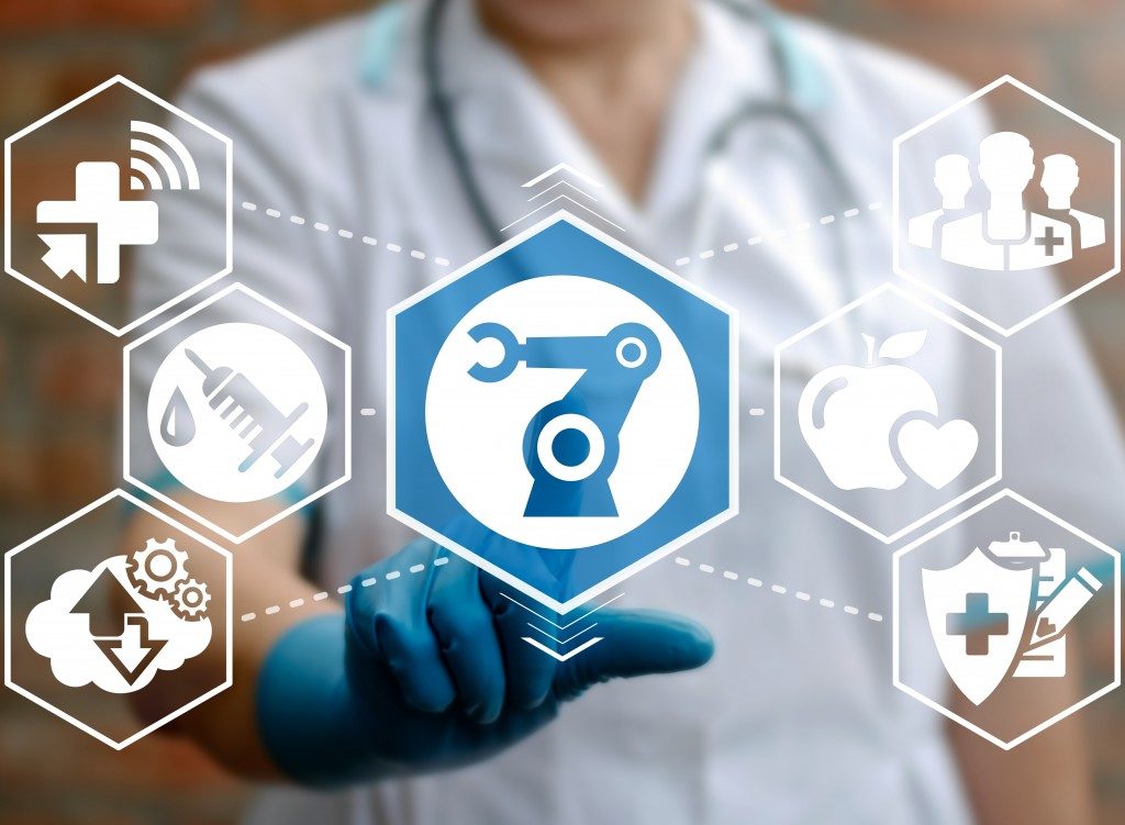 doctor pointing to abstract icons in the healthcare industry