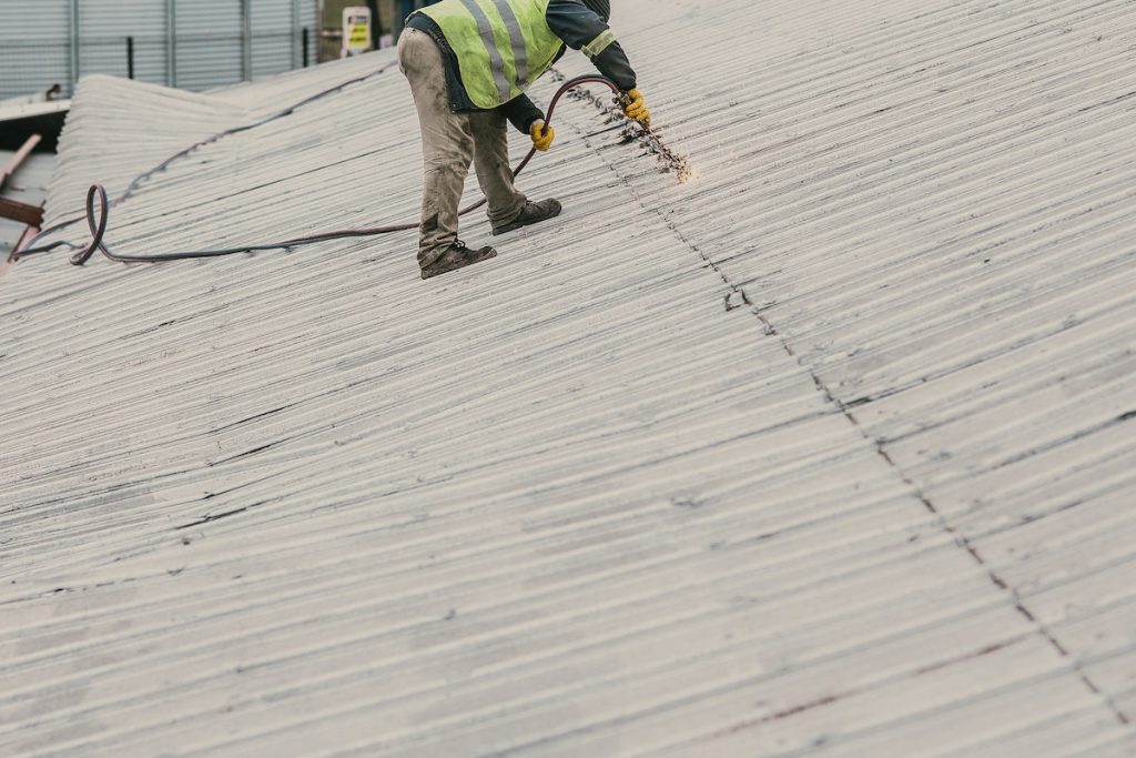 Serviceman doing Metal Work on a Roof