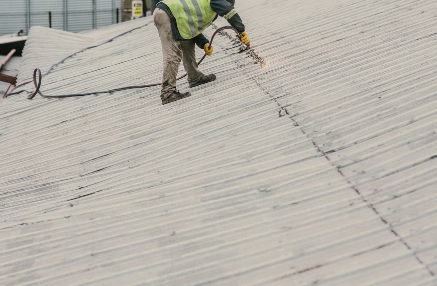 Serviceman doing Metal Work on a Roof